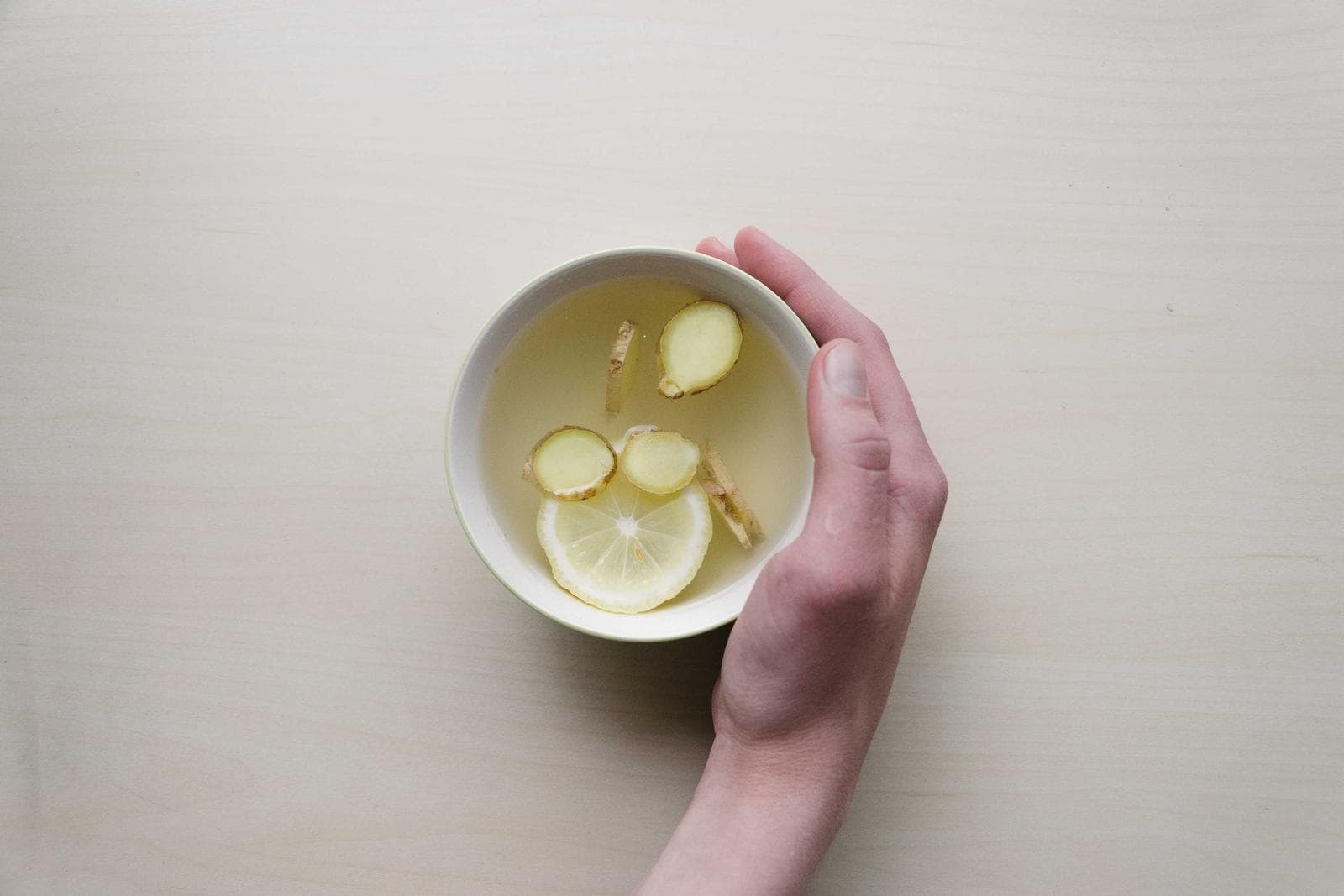 A hand around a small cup