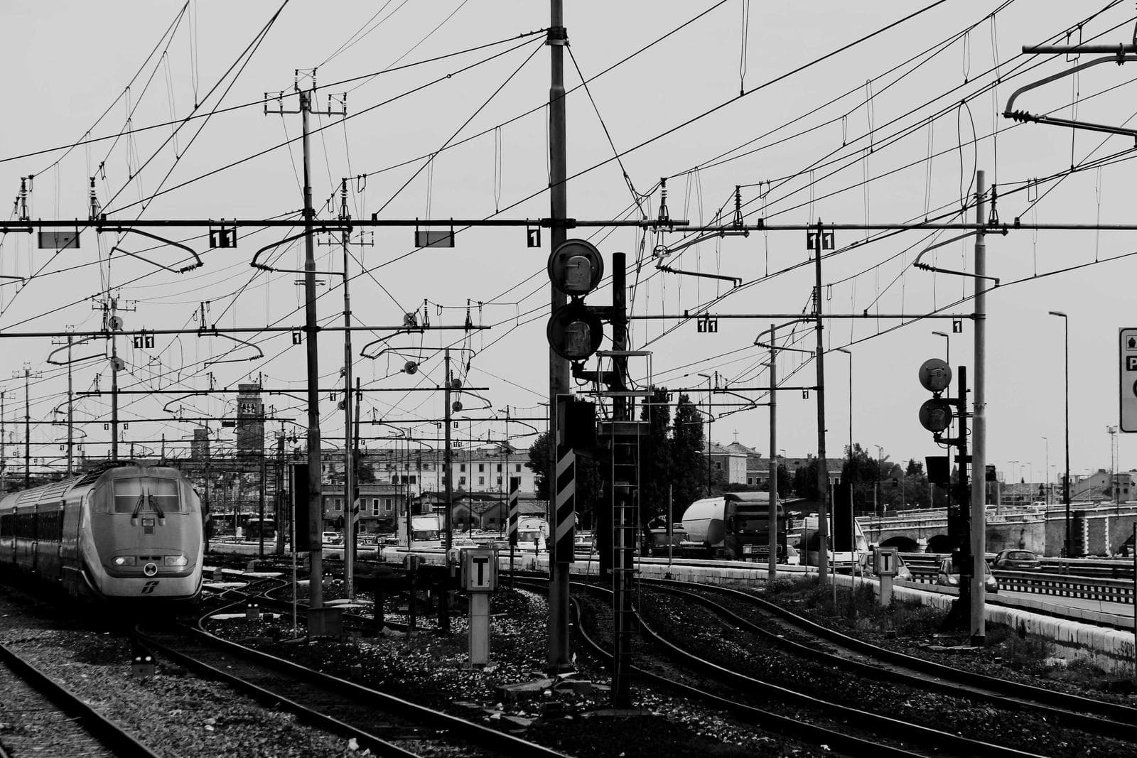 Overhead tram wires against a pale sky