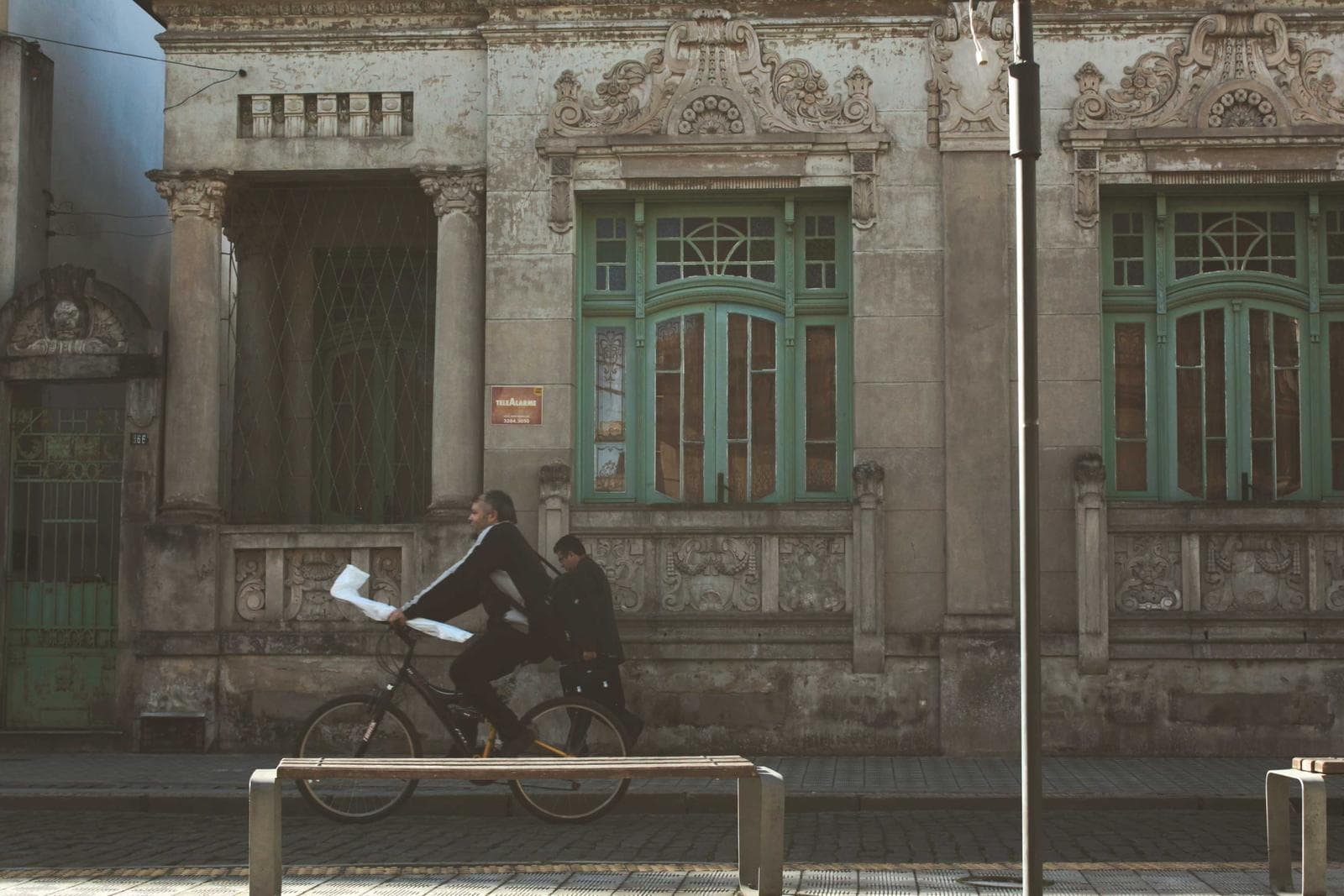 An old facade with a cyclist passing